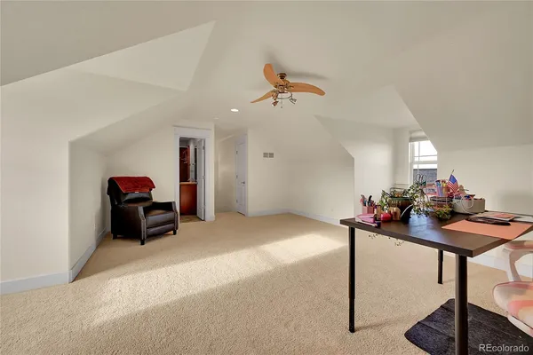 a living room with furniture a table and kitchen view
