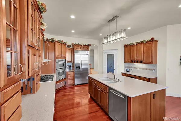 a large kitchen with lots of counter space dining table and sofas