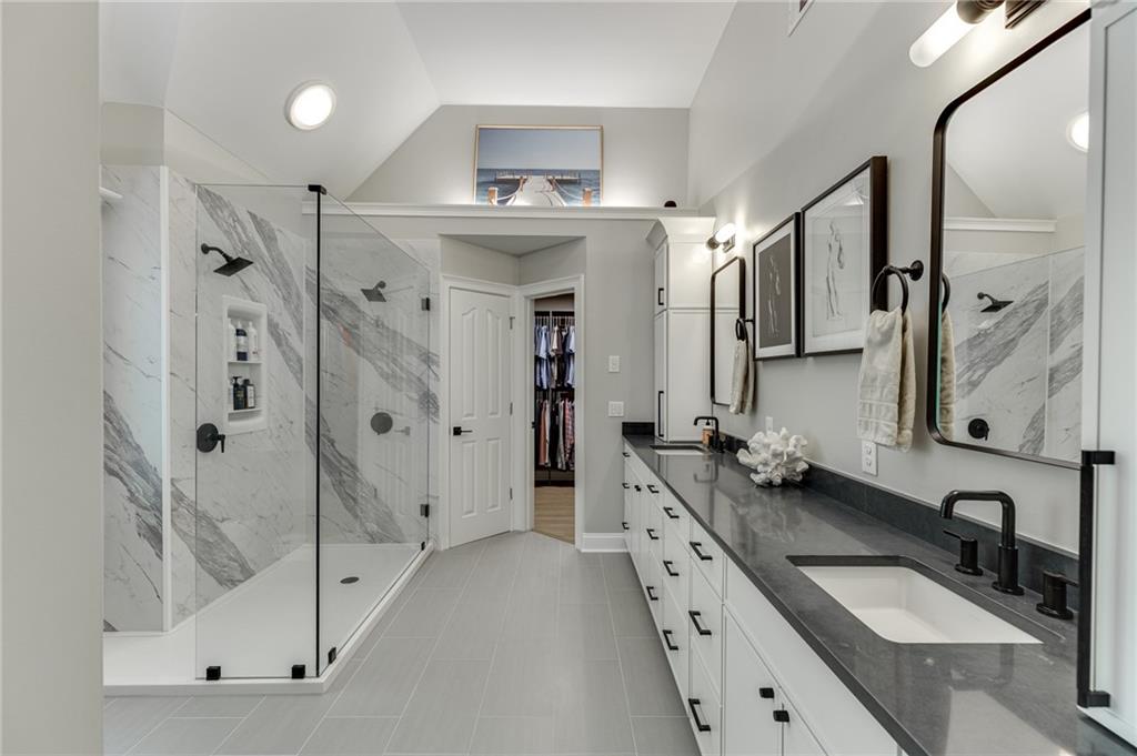 2758 Pathview Drive Dacula, GA 30019 - Photo 5 of 48 a bathroom with a granite countertop double vanity sink mirror and shower