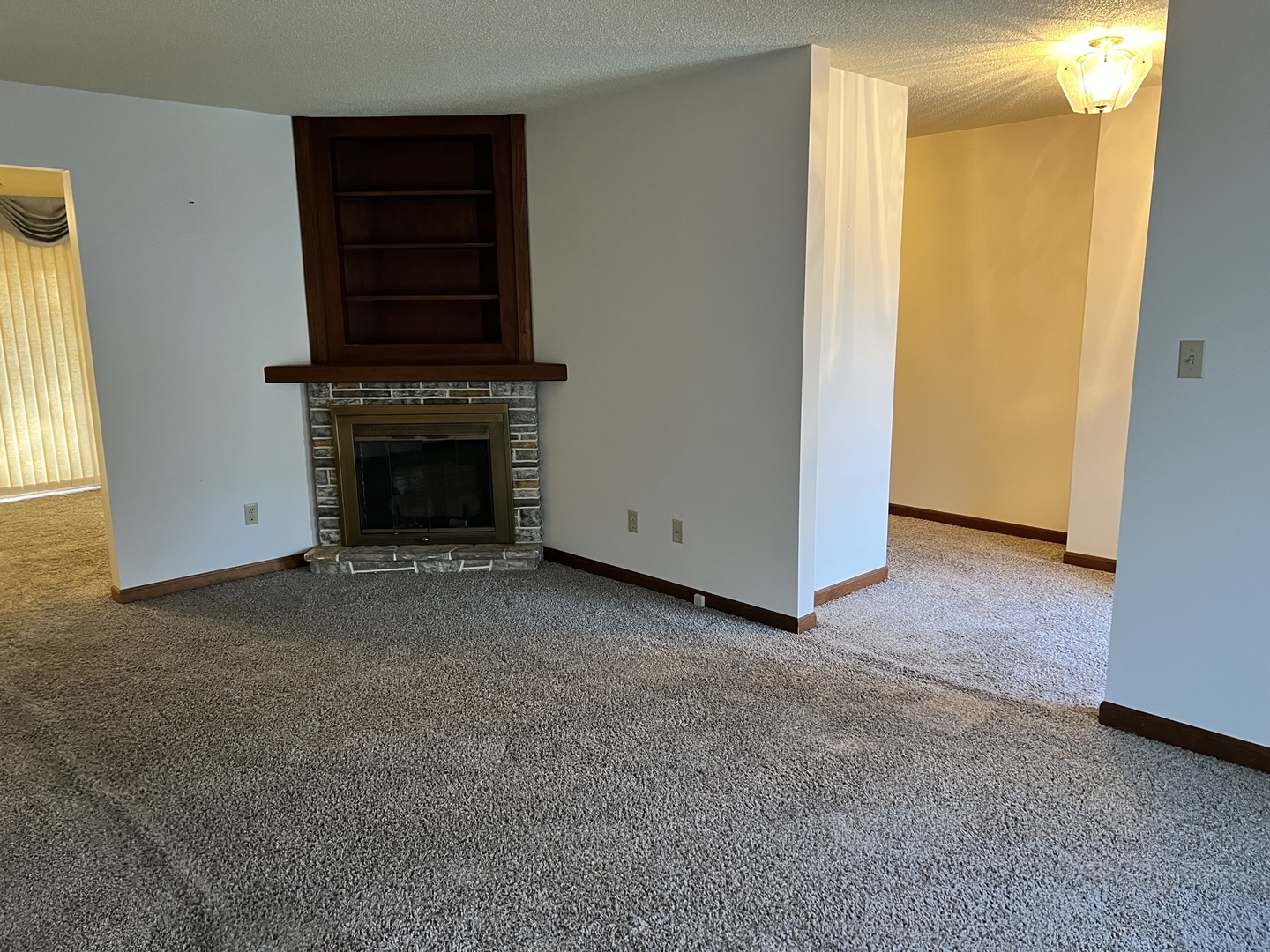 52 Sadowski Court, Unit D Decatur, IL 62521 - Photo 13 of 54 a view of an empty room with fireplace and a window