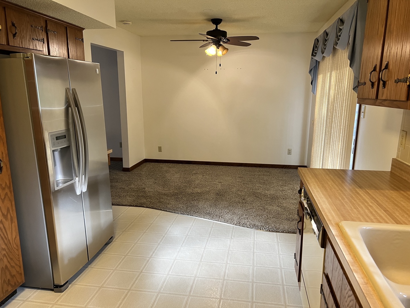 52 Sadowski Court, Unit D Decatur, IL 62521 - Photo 24 of 54 a view of a refrigerator in kitchen and an empty room
