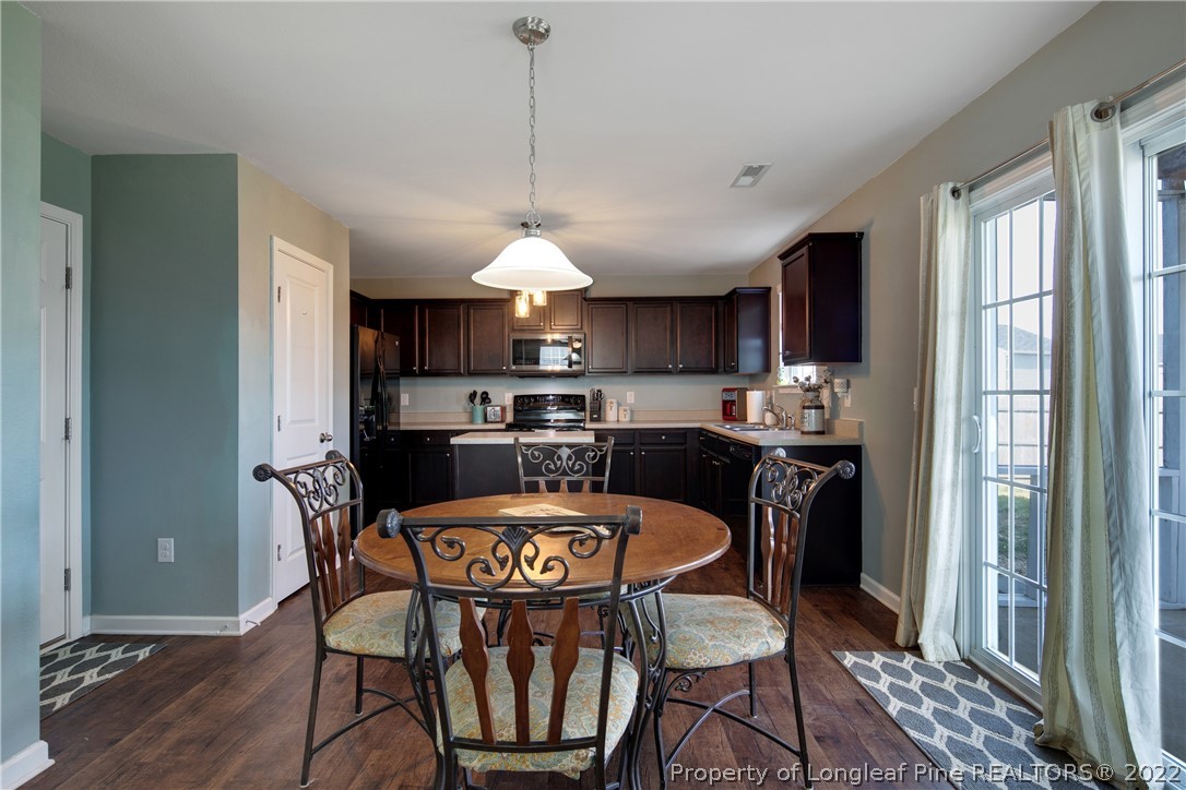 445 Botanical Court Bunnlevel, NC 28323 - Photo 15 of 38 a view of a dining room with furniture window and wooden floor