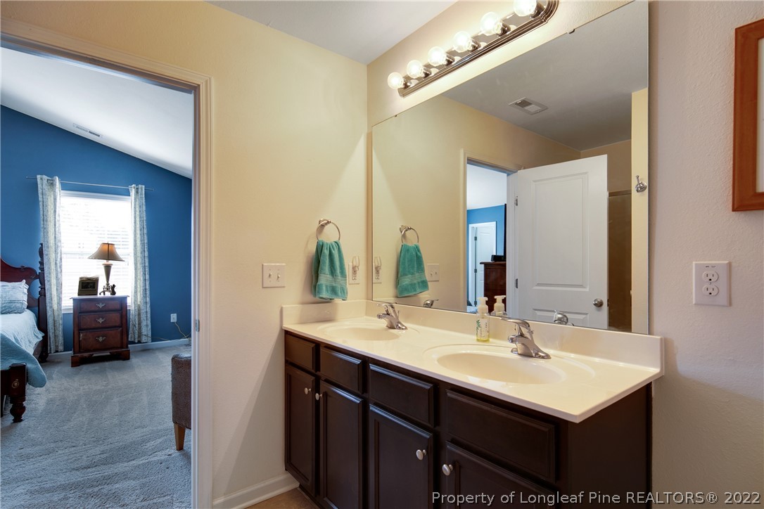 445 Botanical Court Bunnlevel, NC 28323 - Photo 18 of 38 a bathroom with a sink and a mirror