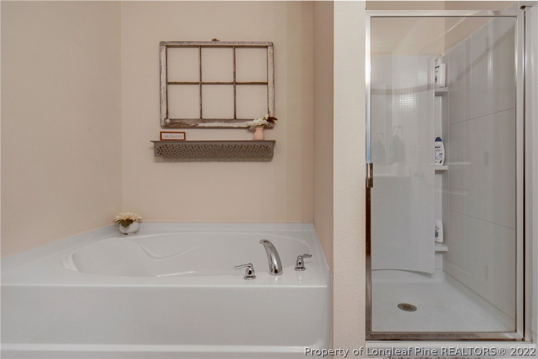445 Botanical Court Bunnlevel, NC 28323 - Photo 19 of 38 a bathroom with a bathtub and a shower
