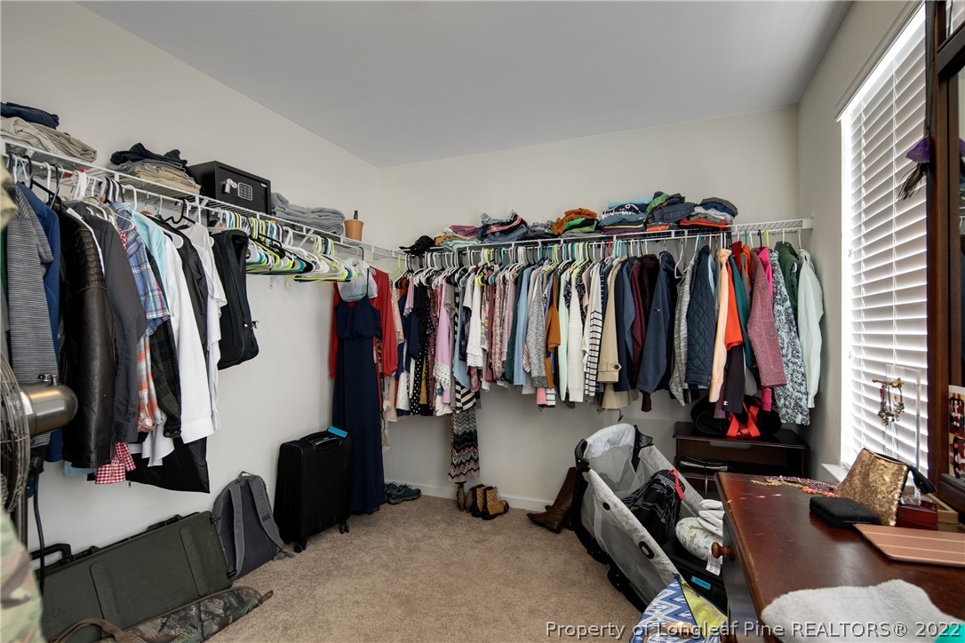 445 Botanical Court Bunnlevel, NC 28323 - Photo 20 of 38 a view of walk in closet with clothes