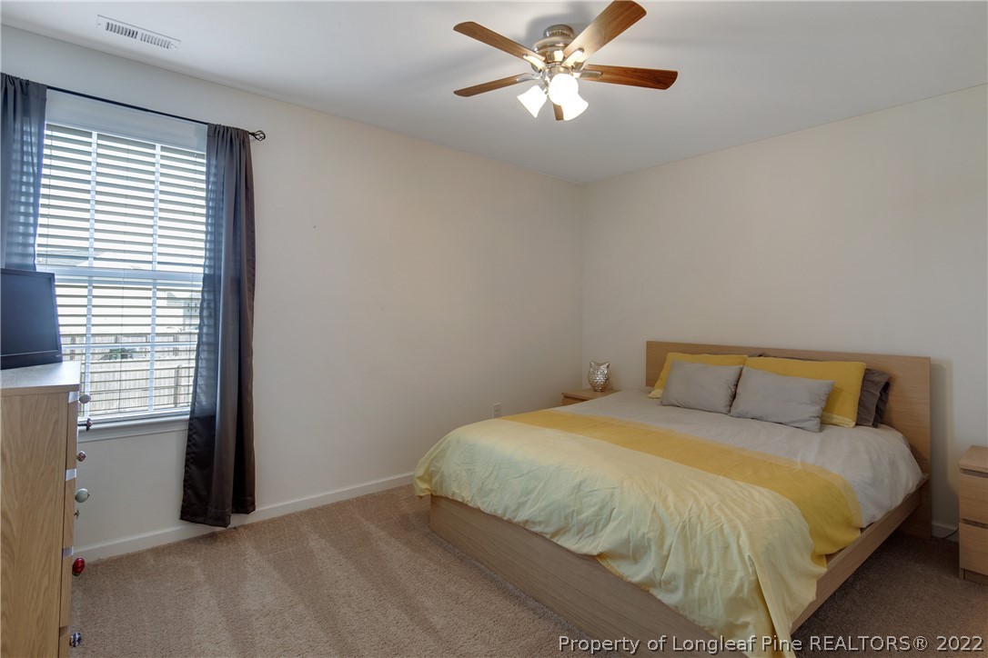 445 Botanical Court Bunnlevel, NC 28323 - Photo 21 of 38 a bedroom with a bed and a window