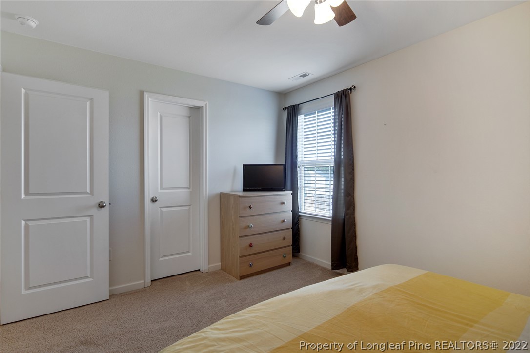 445 Botanical Court Bunnlevel, NC 28323 - Photo 22 of 38 a bedroom with a bed and a television
