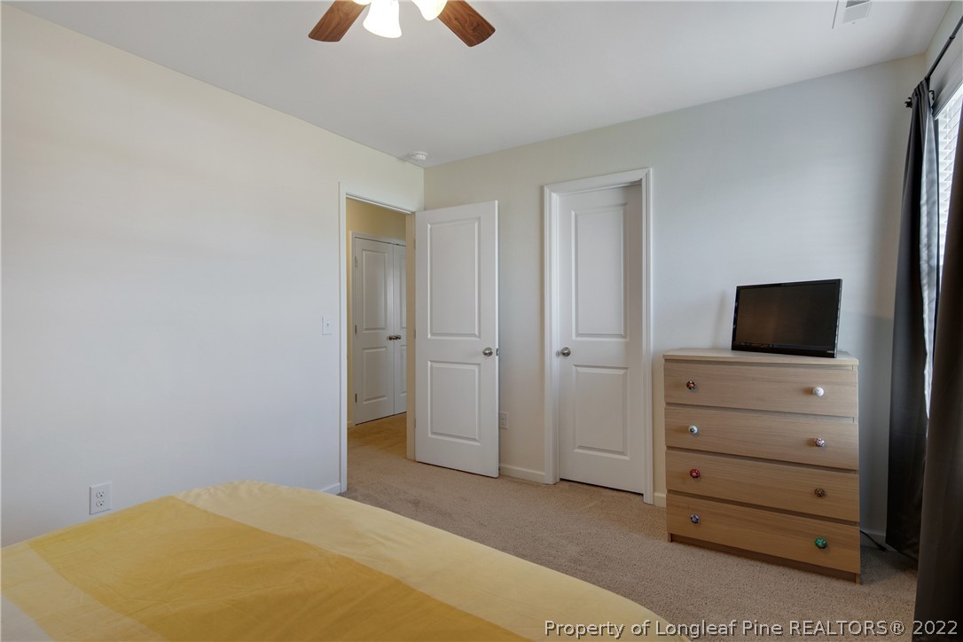 445 Botanical Court Bunnlevel, NC 28323 - Photo 23 of 38 a bedroom with a bed and a television