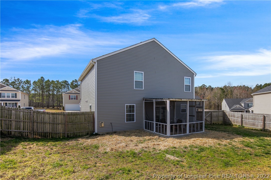 445 Botanical Court Bunnlevel, NC 28323 - Photo 31 of 38 a view of a house with a yard and wooden fence