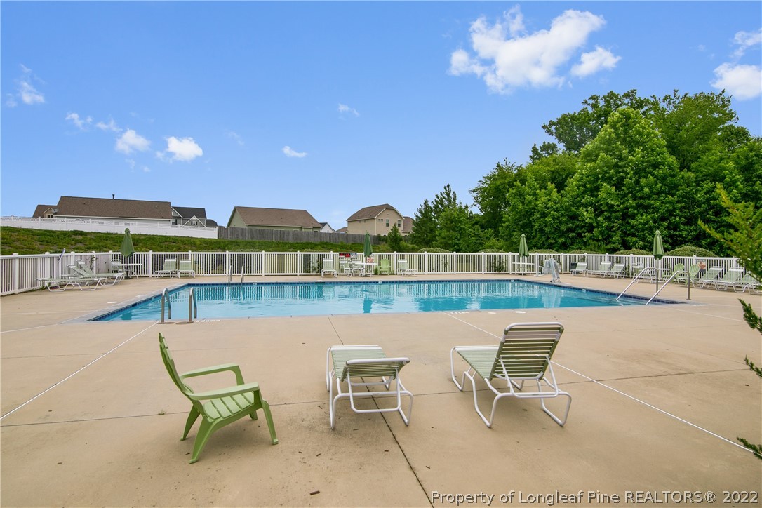445 Botanical Court Bunnlevel, NC 28323 - Photo 35 of 38 a view of a lake with table and chairs
