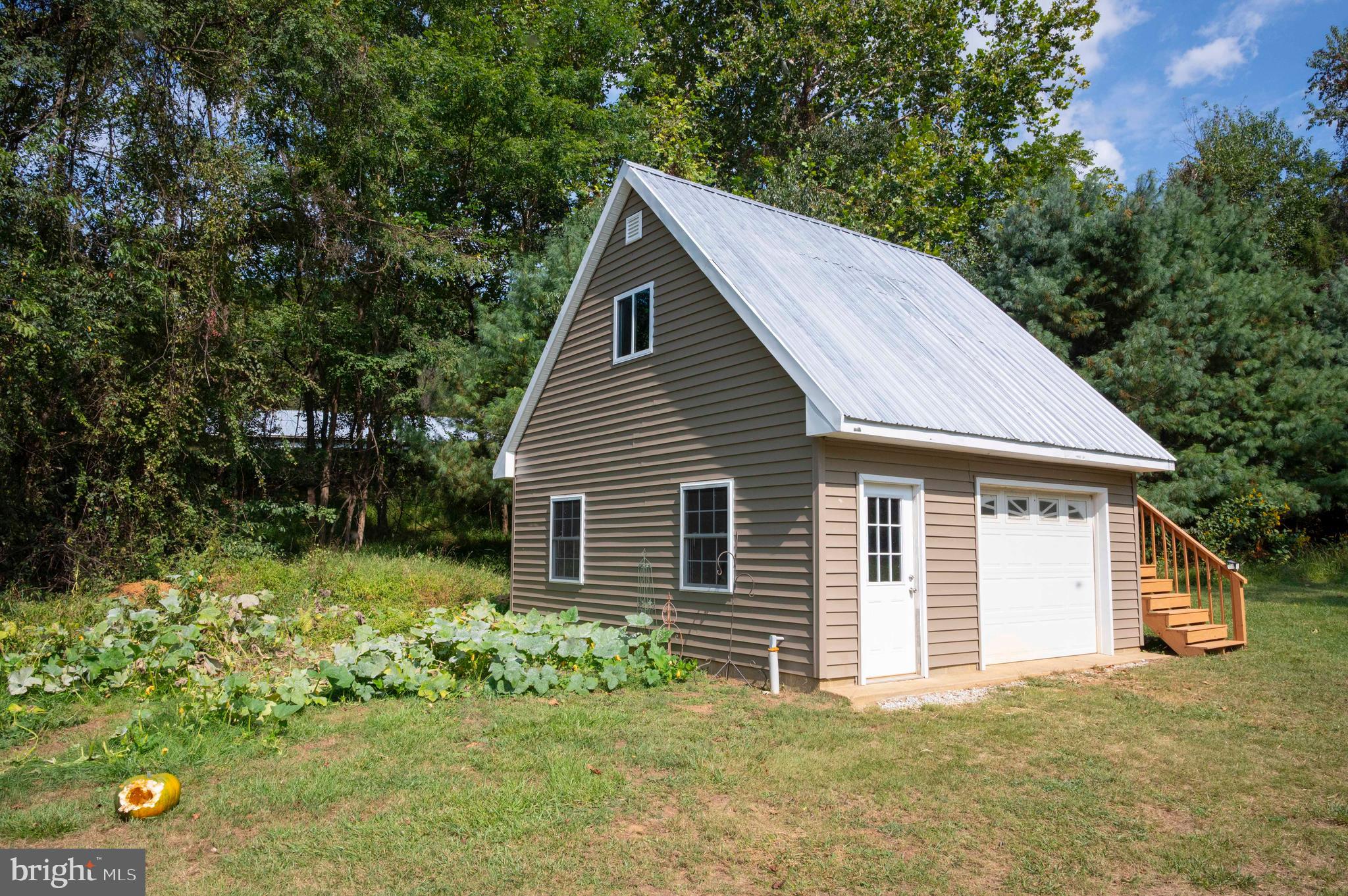 2002 Balkamore Hill Road Stanley, VA 22851 - Photo 12 of 45 a backyard of a house with plants and large tree