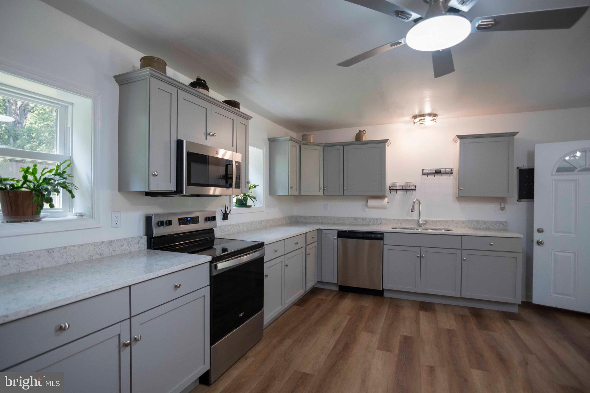 2002 Balkamore Hill Road Stanley, VA 22851 - Photo 21 of 45 a kitchen with kitchen island granite countertop stainless steel appliances a sink cabinets and wooden floor