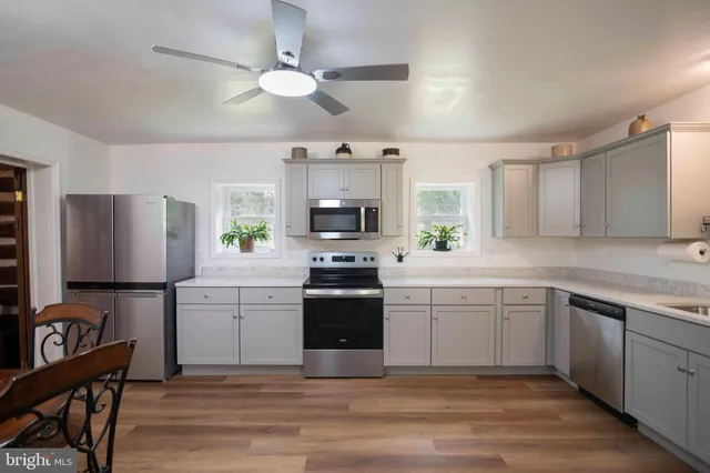 a kitchen with a stove a sink and a refrigerator