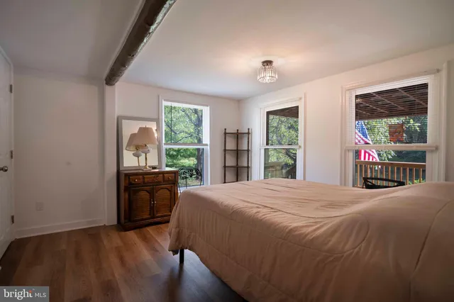 a bedroom with a bed and a large window