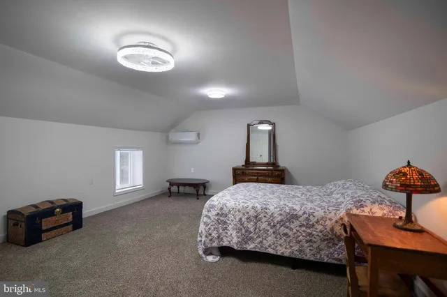 a bedroom with a bed and a chair