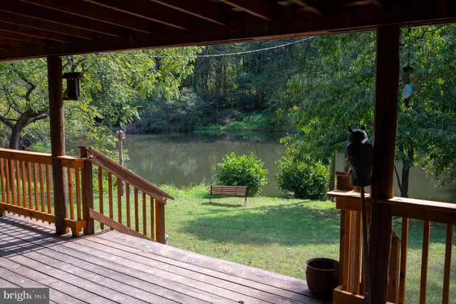 a view of a backyard with wooden floor and outdoor seating