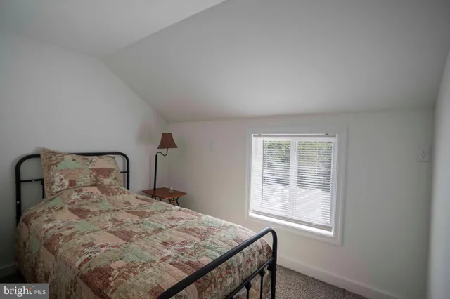 a bedroom with a bed window and with table