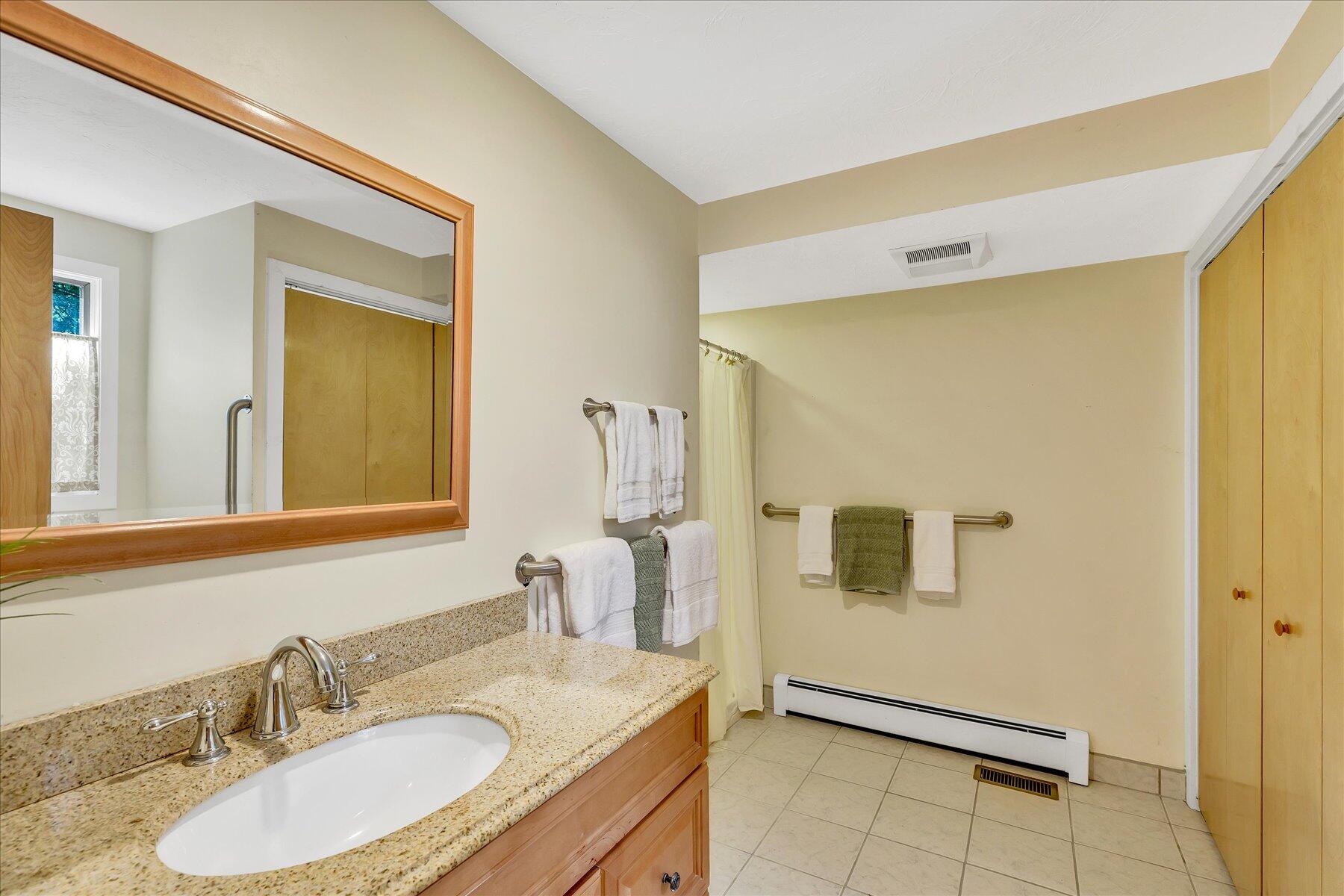 4 Florence Avenue Mashpee, MA 02649 - Photo 32 of 68 a bathroom with a granite countertop sink and a mirror