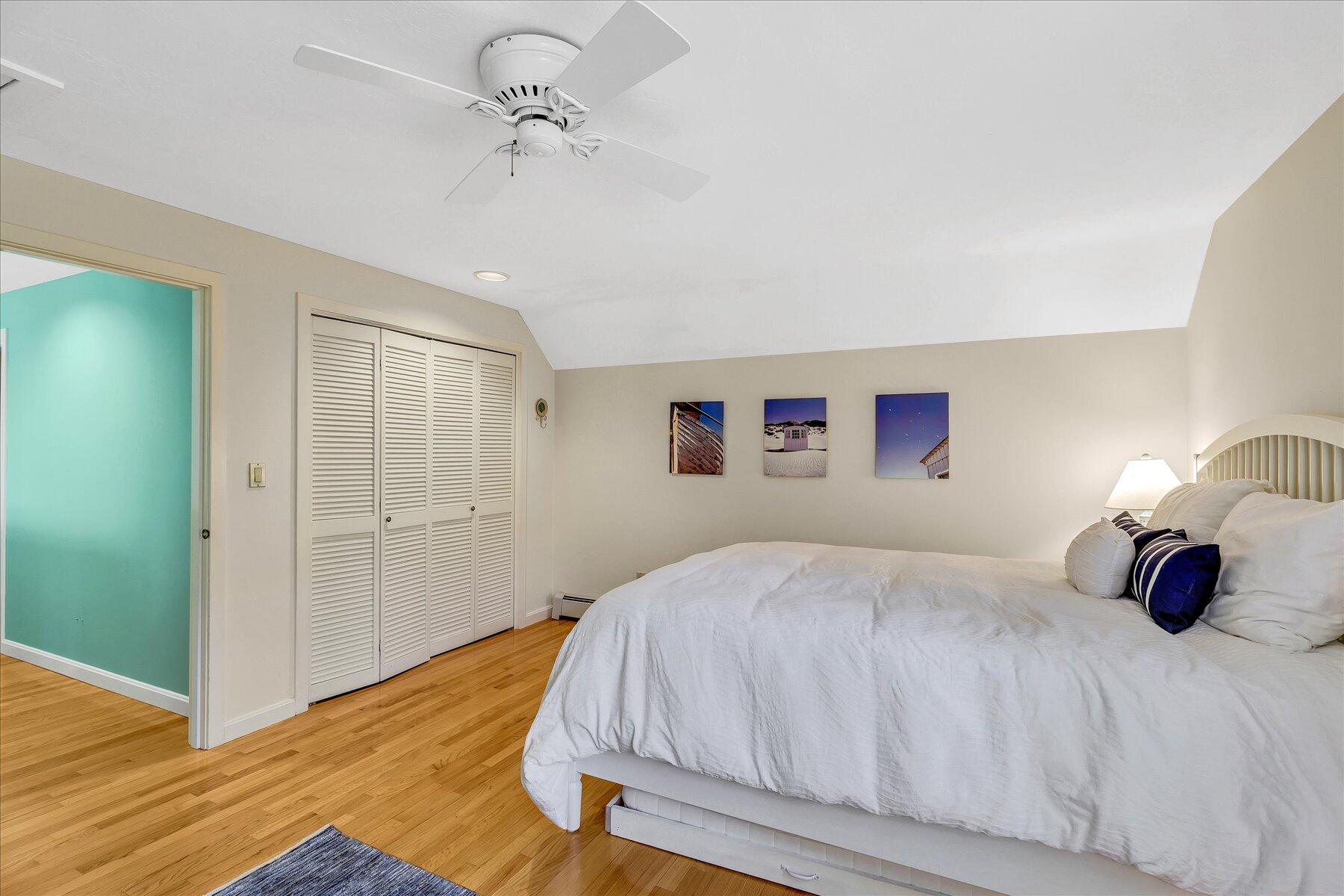 4 Florence Avenue Mashpee, MA 02649 - Photo 42 of 68 a bedroom with a bed and a chandelier