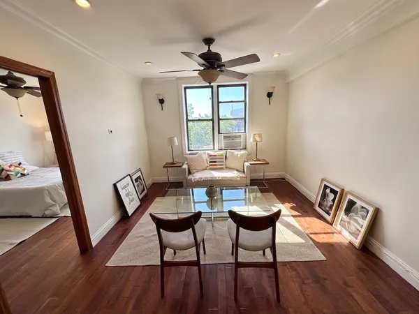 a view of a livingroom with furniture window and wooden floor