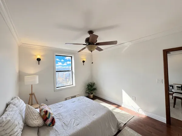 a bedroom with a bed and a chandelier
