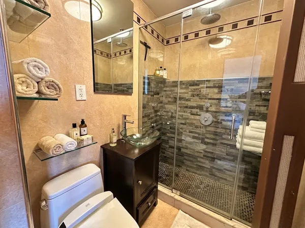 a bathroom with a shower and a sink