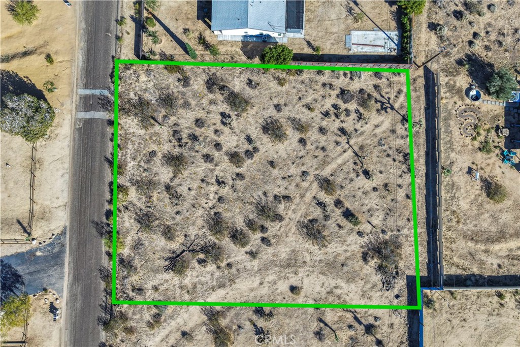 7199 Olympic Road Joshua Tree, CA 92252 - Photo 1 of 12 a view of a road with a fence