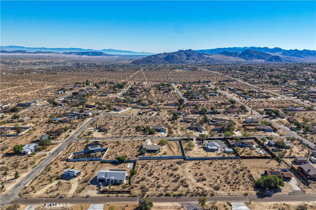 7199 Olympic Road Joshua Tree, CA 92252 - Photo 4 of 12 an aerial view of residential house and sandy dunes
