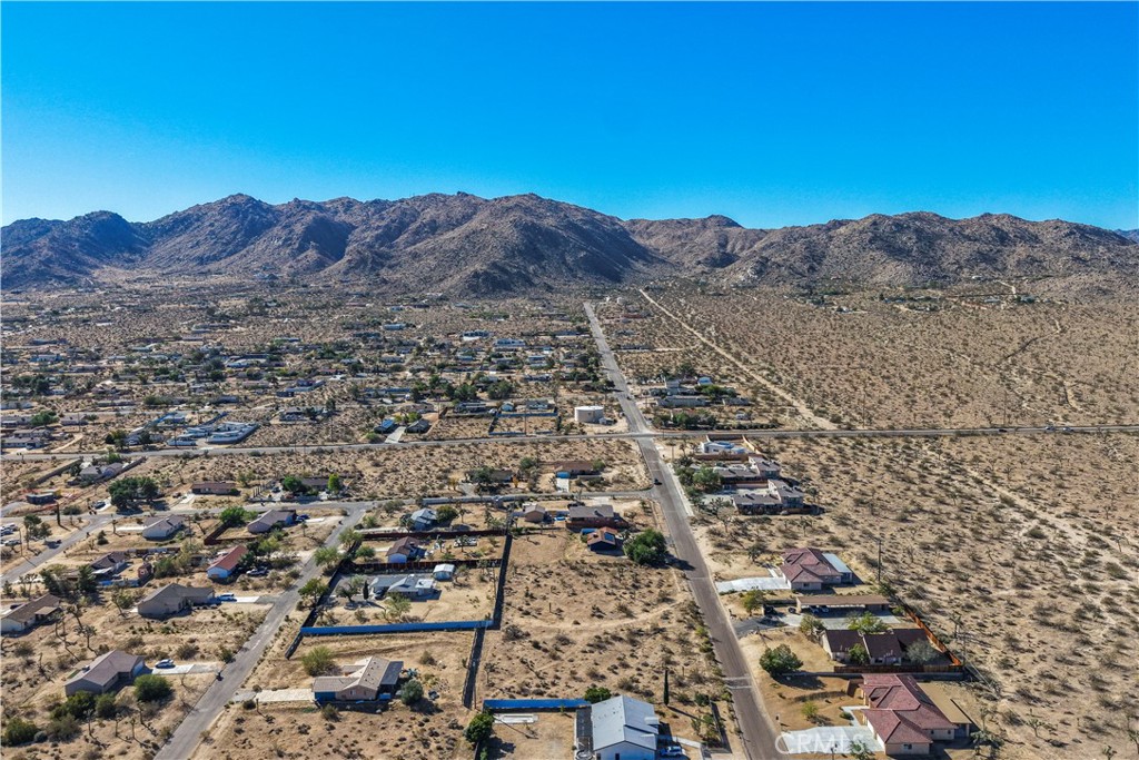 7199 Olympic Road Joshua Tree, CA 92252 - Photo 5 of 12 an aerial view of residential house and sandy dunes