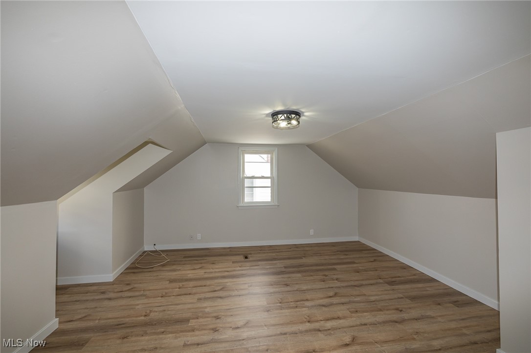 16002 Turney Road Maple Heights, OH 44137 - Photo 22 of 29 Additional living space with light wood-type flooring and vaulted ceiling