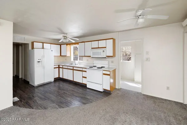 a kitchen with a refrigerator and a stove top oven