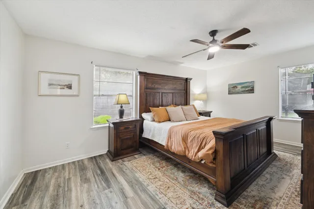 a bedroom with a bed and wooden floor
