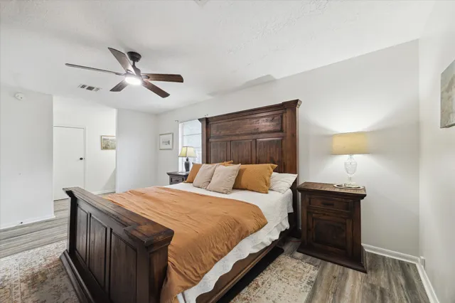 a bedroom with a bed and a lamp