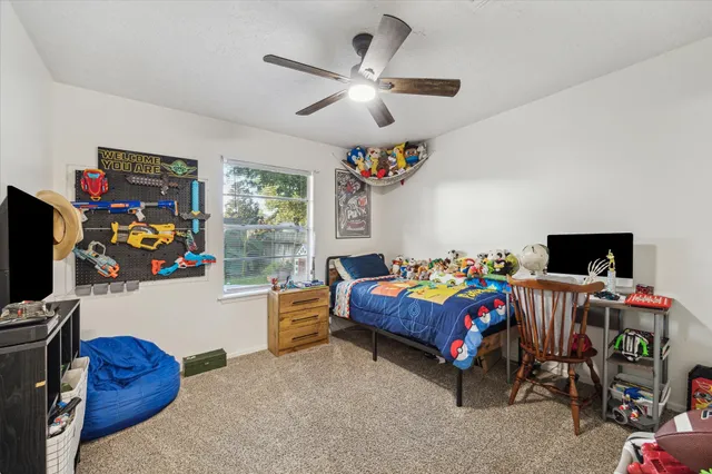 a bedroom with a bed and a tv