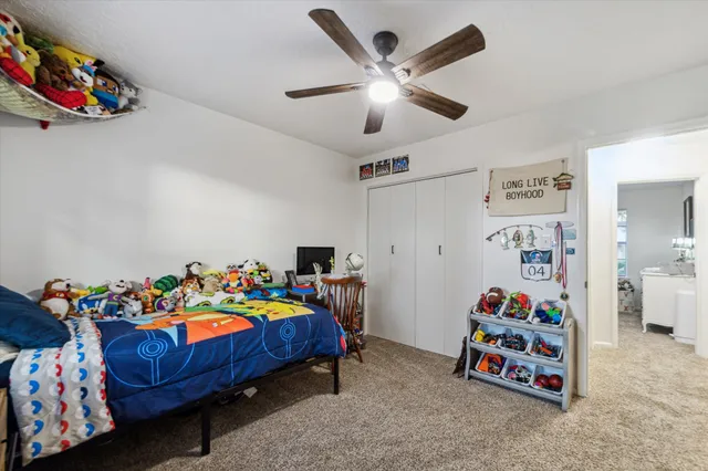 a bedroom with a bed and a wooden floor
