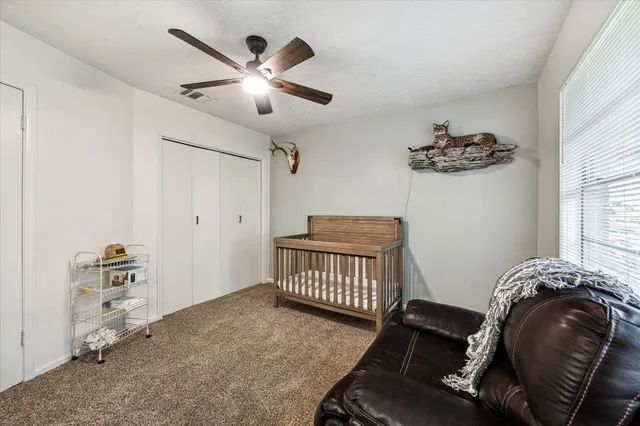 a bedroom with furniture and a window