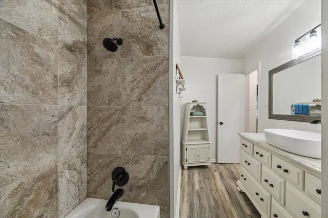 a bathroom with a sink a mirror and shower