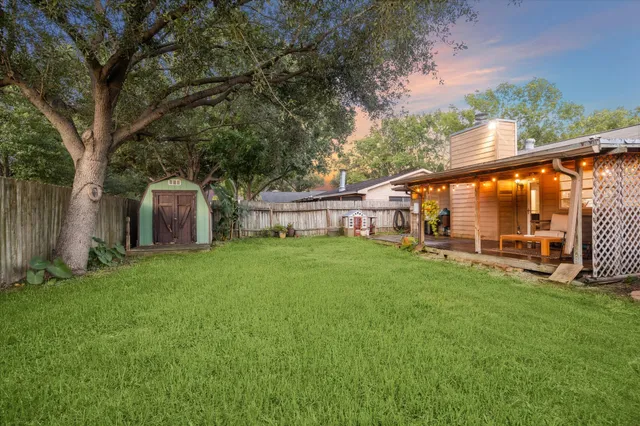 a view of a house with a backyard and a patio