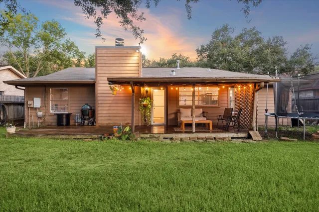 a front view of a house with a yard and trees