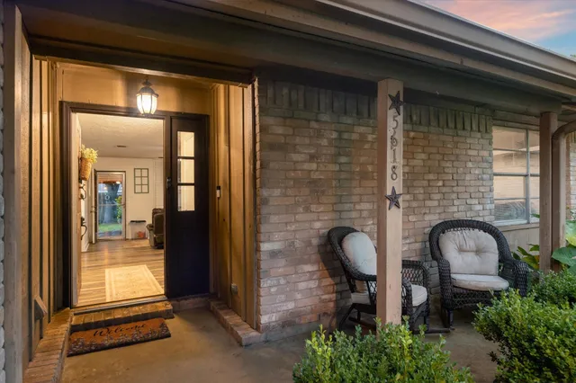 a front view of a house with outdoor seating