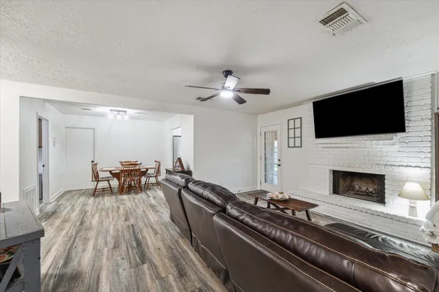 a living room with furniture fireplace and flat screen tv
