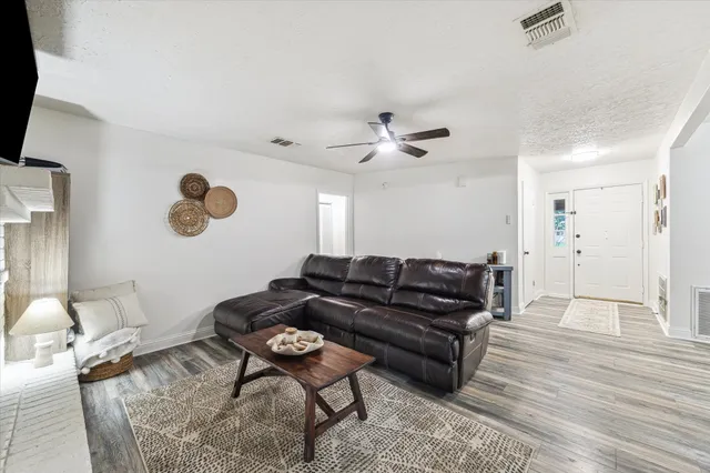 a living room with furniture and wooden floor