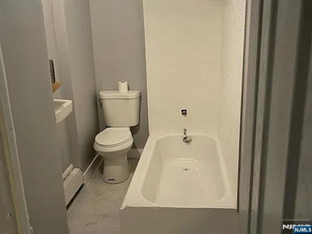 489 Market Street, Unit 2 Paterson, NJ 07501 - Photo 2 of 6 a bathroom with a toilet and a sink