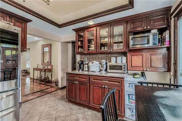 a kitchen with stainless steel appliances granite countertop a refrigerator and a stove top oven