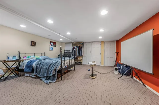 a spacious bedroom with a bed and a desk in it