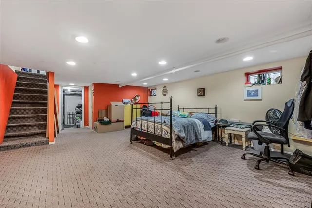 a bedroom with furniture and a chair