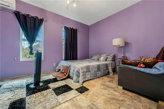 a bedroom with a bed and a potted plant