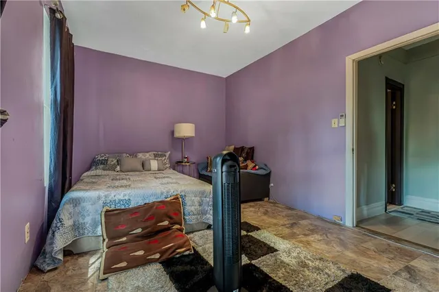 a bedroom with a bed and a chandelier