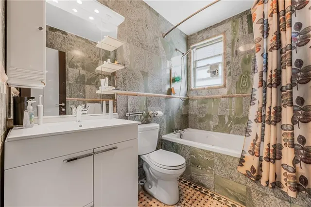 a bathroom with a sink toilet a mirror and shower