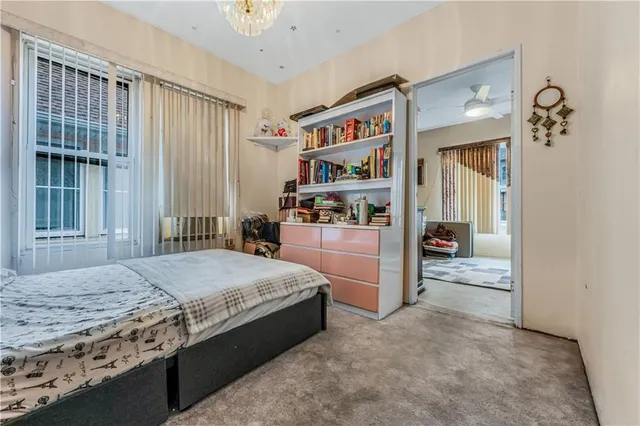 a spacious bedroom with a bed and a cabinets